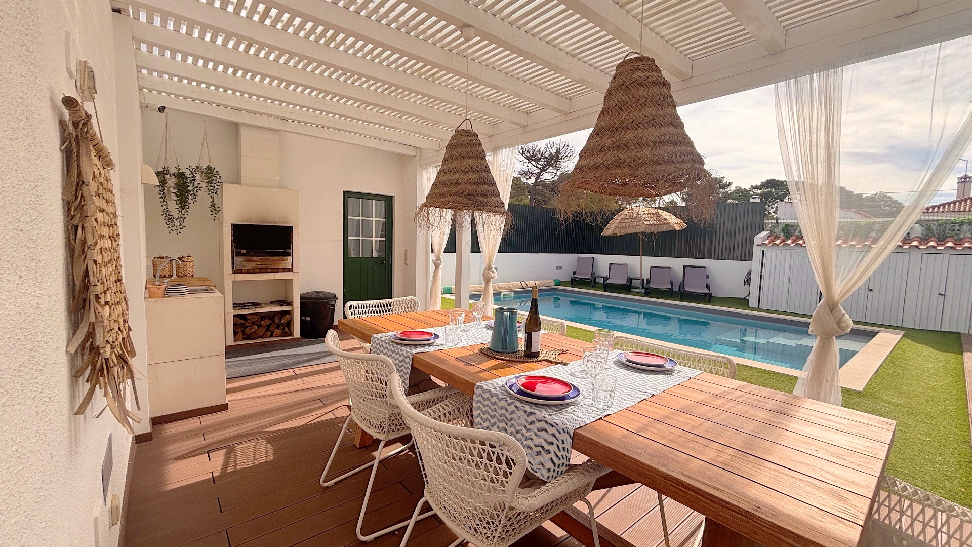 Shaded pergola outdoor dining set beside private swimming pool